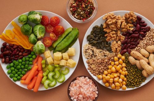 Vibrant display of assorted vegetables, legumes, nuts, and seeds on plates, perfect for healthy eating images.